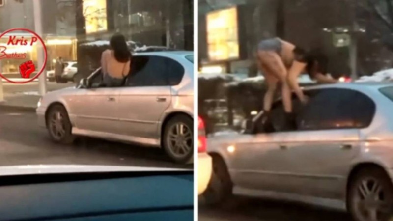 Алматыда жартылай жалаңаш киінген қыз жүріп бара жатқан көліктің төбесіне шықпақ болды (видео)